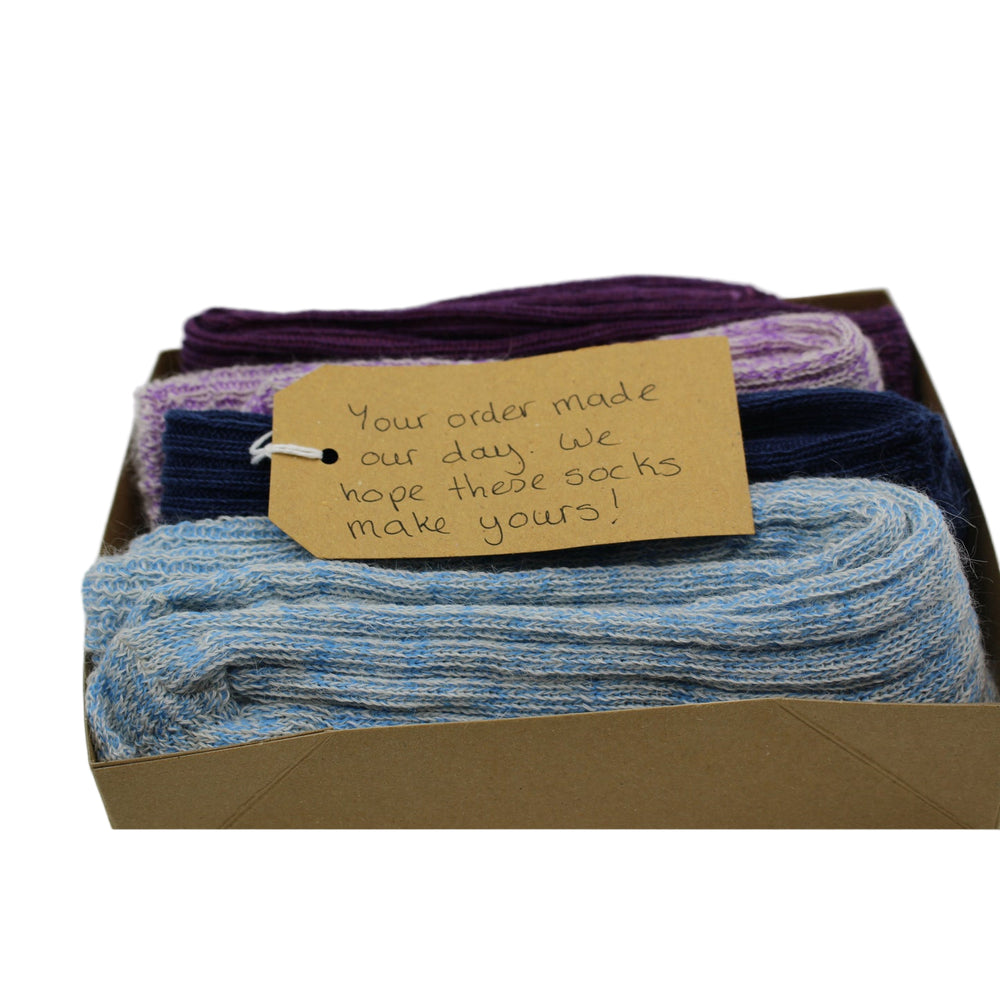 
                      
                        Gift Box of socks with a handwritten tag on a light grey background
                      
                    